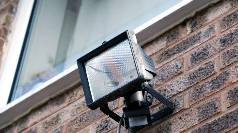 Sensor floodlight mounted on a brick wall
